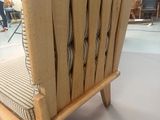 a chair made out of wood with a seat made out of a piece of wood
