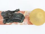 sculpture of a man laying on a marble slab with a hat on top of it