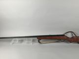 a rifle on a white background with a wooden handle