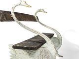 two white swans that are sitting on top of each other