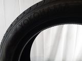 a close up of a tire on a table with a white background