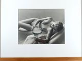 a black and white photo of a woman laying on a couch