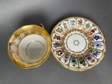 a close up of a cup and saucer on a table