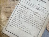 several old papers are stacked on top of each other on a table