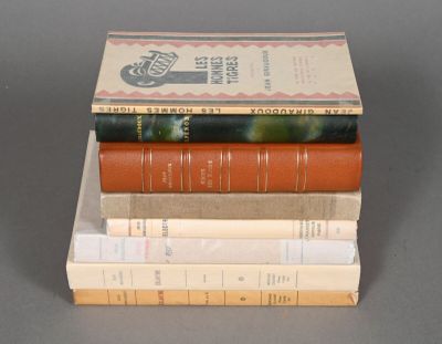 several books are stacked on top of each other on a table