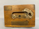 an old wooden box with a metal latch on it