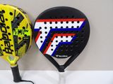 two tennis rackets sitting next to each other on a table