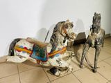two wooden horses that are standing next to each other