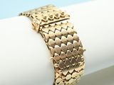 a close up of a napkin with a gold bracelet on it