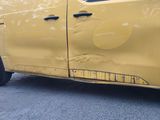 a yellow van that has been damaged and is parked on the side of the road