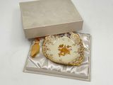 a small plate in a box on a white surface