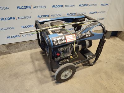 the generator is sitting on the floor in front of the wall