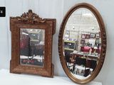 two mirrors sitting on a white table in front of a mirror