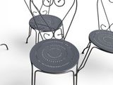 three black wrought chairs sitting next to each other on a white surface