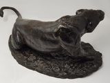 bronze sculpture of a bull on a rock on a white background