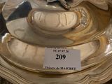 a silver plate with a silver lid on a table