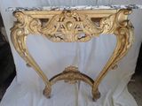 a marble top table with a gold frame and a marble top