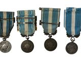 three medals are shown in a row on a white background