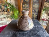 a small vase sitting on a table in a room