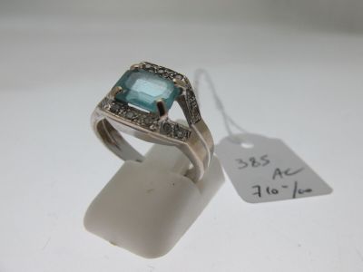 a ring that has a blue stone in it