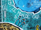 a painting on the wall of a building that has graffiti on it