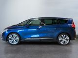a blue car parked in a garage with a white wall