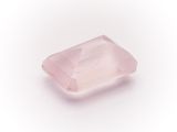 a pink quartz stone on a white background