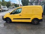 a yellow van parked in a parking lot next to a building