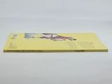 a yellow book sitting on top of a white table