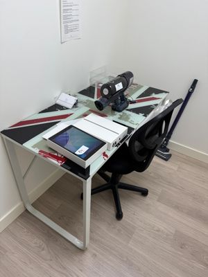 a desk with a laptop and a tablet on it
