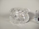 a small glass jar with a lid and a small glass jar with a lid