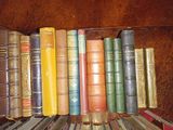a lot of books that are sitting on a shelf