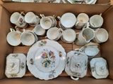 a box full of china dishes and cups and saucers