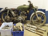a motorcycle that is sitting in a garage next to some tools
