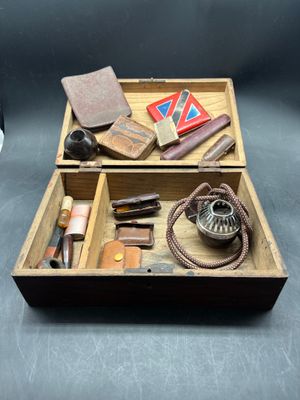 a wooden box filled with various items on a table