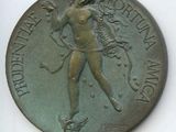 une vieille médaille en bronze représentant une femme tenant une épée