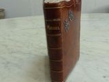 a brown book sitting on top of a marble table