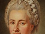 portrait of a woman in a blue dress and a white bonnet