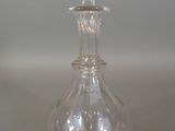 a clear glass bottle with a flower on the top of it