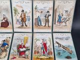 several cards with pictures of people and animals on them on a black surface