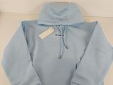 blue hoodie with a white tag on the front of it