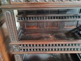a wooden cabinet with a glass door on top of it