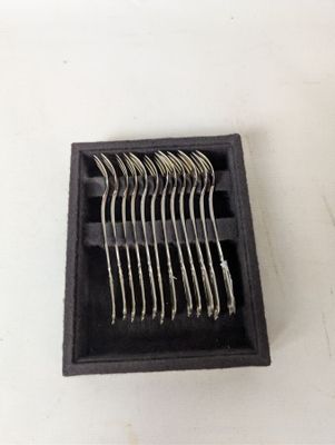 a picture of a set of forks and spoons in a black box