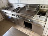 a kitchen with a stove, oven, and sink in it