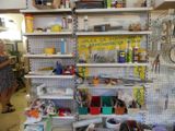 a woman that is standing in front of a wall of tools