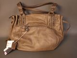 brown leather handbag with a tag on it sitting on a table