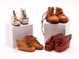 plusieurs paires de chaussures pour bébé posées sur des cubes blancs