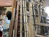 a man standing on a ladder in a room with a lot of ladders
