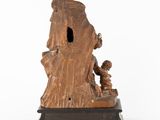 an old statue of a man with a child in his lap