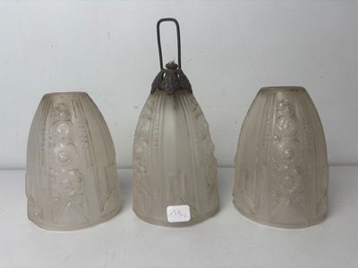 three glass vases are sitting on a table with a white background